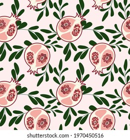 Seamless pattern with pomegranate and twigs. Abstract pomegranate seeds in the section with a pink background