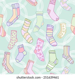 Seamless pattern. Printing on the fabric. Colorful funny socks on a blue background.