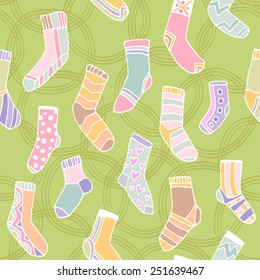 Seamless pattern. Printing on the fabric. Colorful funny socks on a grassy green background.