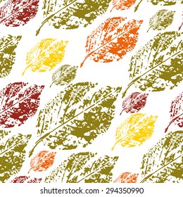 seamless pattern prints birch leaves in autumn colors on a white background