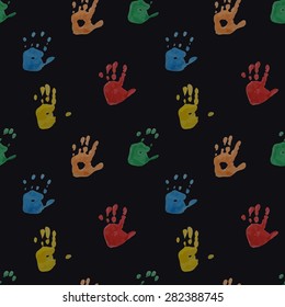 Seamless pattern. Prints of children's handprints. Colorful prints on a dark background. Vector, EPS10