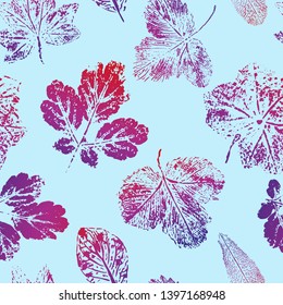Seamless pattern of prints of red-blue leaves on a blue background. Vector