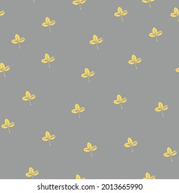 Seamless pattern with prints of yellow leaves on a trendy gray background. Grunge leaf print. Printing on fabric, wallpaper, packaging, stylized as a stamp or leaf print