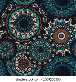 Seamless pattern with a Psychedelic kaleidoscope footage. Mandala ornament. Stylized dark green and brown flowers on a black background. Floral motif. Vector illustration.