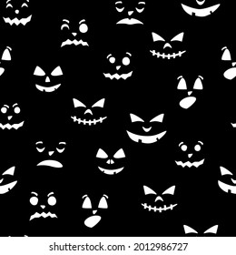 Seamless pattern of pumpkin silhouettes with different emotions on a black background. Autumn ornament for the Halloween holiday. Vector illustration.