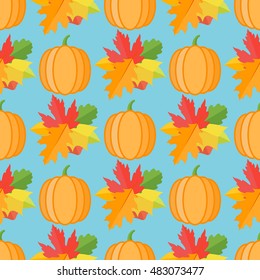 Seamless pattern with pumpkins and autumn leaves on blue background. Vector texture.