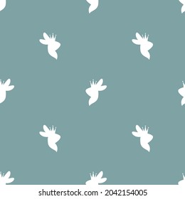 Seamless pattern with rabbits and crowns on powder blue background. Decorative holiday wallpaper, good for printing. Simple Easter Vector illustration. Fantasy fairylale ornament or texture.