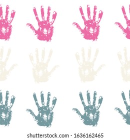 Seamless pattern with rainbow colored family hand prints on white background.  Endless pattern with multiply effect. Multicolor backdrop for your design.
