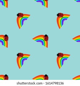Seamless pattern rainbow and ladybug on a blue background. Vector.