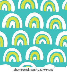 Seamless pattern with rainbow on a blue background.