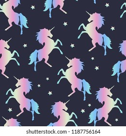 Seamless pattern of rainbow unicorns on a blue background. For boys and girls. for textiles.