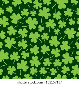 A seamless pattern of random green shamrocks.