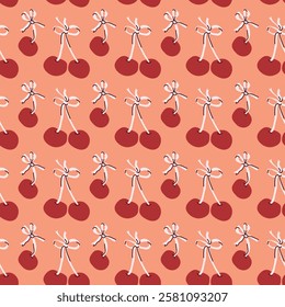 Seamless pattern of red cherries with stems on peach background.