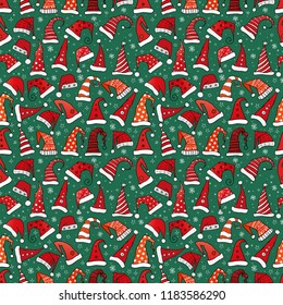 Seamless pattern with red Christmas Santa hats on dark green background. Vector illustration
