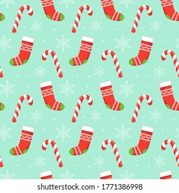 Seamless  pattern with red Christmas stockings, candys and snowflakes on blue  background. Christmas, winter concept for wrapping, wallpaper, backdrop. Vector illustration EPS 10.