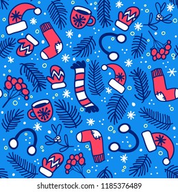 Seamless pattern with red mittens, socks, hats and evergreen branches on blue background. Vector pattern for Christmas, New Year's Day, Winter Holidays. Background for invitation card, gift wrapping