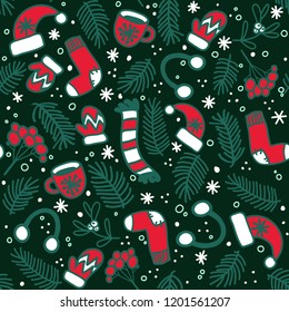 Seamless pattern with red mittens, socks, hats and evergreen branches on dark background. Vector pattern for Christmas, New Year's Day, Winter Holidays. Background for gift wrapping paper, textille