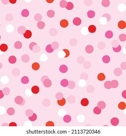 Seamless pattern with red and pink confetti. Simple repeat design with dots