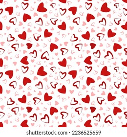 Seamless pattern with red and pink hearts.
