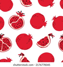 Seamless pattern with red pomegranates and pomegranate slices. Hand drawn pomegranates pattern on white background. for fabric, drawing labels, print, wallpaper of children's room, fruit background