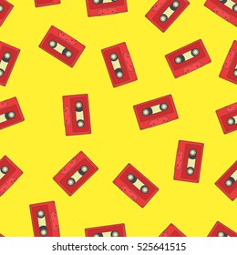 Seamless pattern with red retro audio tape on yellow background.