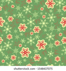 Seamless pattern with red snowflakes on a green background. Vector graphics.