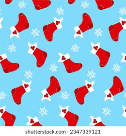 Seamless pattern with red socks, holly berry and sowflakes on blue background. Vector pattern for Christmas, New Year's Day, Winter Holidays. Background for gift wrapping paper, textille