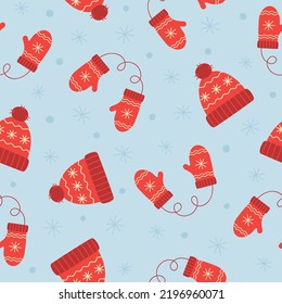 Seamless pattern of red winter hat and mittens. Winter elements on blue background. Doodle style. Vector illustration