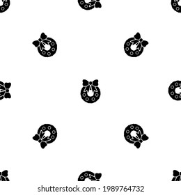 Seamless pattern of repeated black christmas wreath symbols. Elements are evenly spaced and some are rotated. Vector illustration on white background