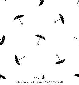 Seamless pattern of repeated black umbrella symbols. Elements are evenly spaced and some are rotated. Vector illustration on white background