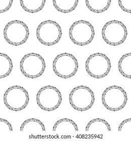 Seamless pattern with repeating circles of three black colored barbed wires on white background