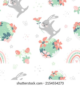 Seamless pattern of repeating drawn rabbit with flower in hand standing on planet earth. Colored dots, butterflies, strawberries and rainbow around. Vector illustration.