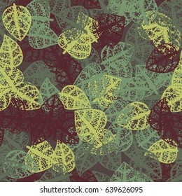 Seamless pattern. Rotten leaves arranged randomly. Fashionable camouflage. Brown, blue-green, yellow-green.