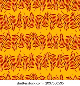 Seamless pattern with rowan leaves on an orange background.