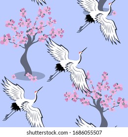 Seamless pattern with sakura tree and white Japanese cranes on a blue background. Vector illustration.For decoration of textiles, packaging, wallpaper, web design.