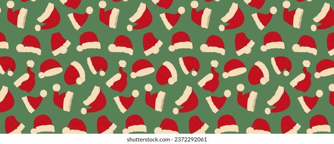 Seamless pattern with Santa Claus hats on a green background. Winter vector illustration.