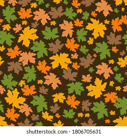 Seamless pattern from scattered autumn leaves. Maple leaves of different colors. Yellow, green, orange and brown. For packaging and wrapping paper