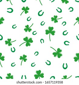 Seamless pattern with with shamrock symbol of Ireland and horseshoe,   Vector  illustration with green clover, hand drawn in doodle  on color background for design, kids decor, wrapping