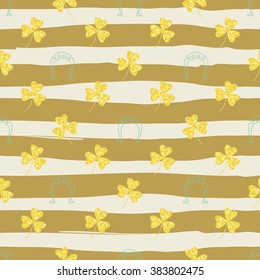 Seamless pattern with shining and glittering gold shamrocks clovers and horseshoes. Pattern for congratulations happy St. Patrick's day. Hand drawn background from strips. Seamless background eps