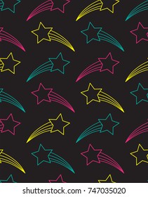 Seamless pattern with shooting stars in blue, pink and yellow, on black background.