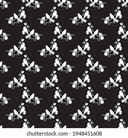 Seamless pattern with silhouette of birds sitting on twigs. Vector background with branches of tree. Decorative vintage wallpaper with birds and leaves