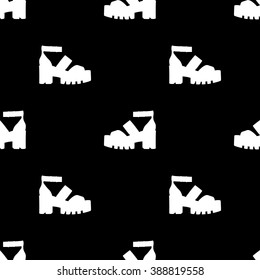 Seamless pattern with silhouette of fashionable footwear on a thick platform heel. In two colors white silhouette of shoes on a black background.