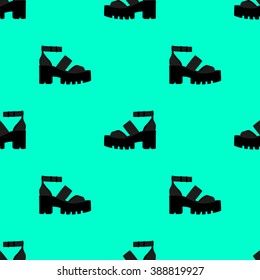 Seamless pattern with silhouette of fashionable footwear on a thick platform heel. In two colors black silhouette of shoes on a green aquamarine background.