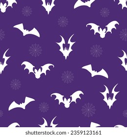  Seamless pattern of silhouettes of bats with cobwebs on a blue background.