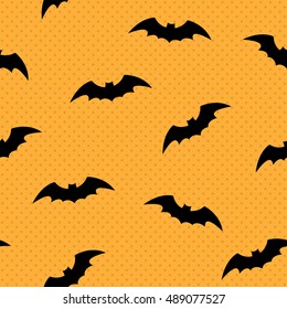 Seamless pattern with silhouettes of bats. Polka dot background for Halloween. Good for design of wrapping paper, invitation and greeting cards.