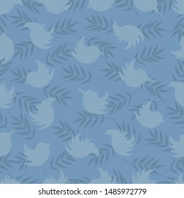 Seamless pattern of silhouettes of birds and rowan leaves in soft blue tones