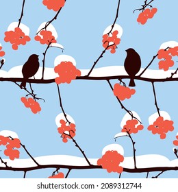 Seamless pattern of silhouettes birds sitting on rowan branches on snowy frosty winter day