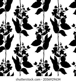 Seamless pattern. A pattern with silhouettes of branches, flowers and leaves. Black and white pattern. Black silhouettes on a white background. It can be used in the design of fabrics,wallpaper,paper.