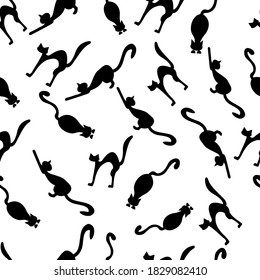 Seamless pattern of silhouettes of cats on a white background