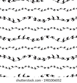 Seamless pattern of silhouettes flocks flying geese in rows